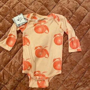 Kate Quinn long sleeve peace’s bodysuit